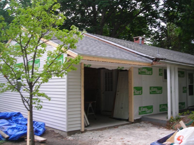 Installing new light gray siding